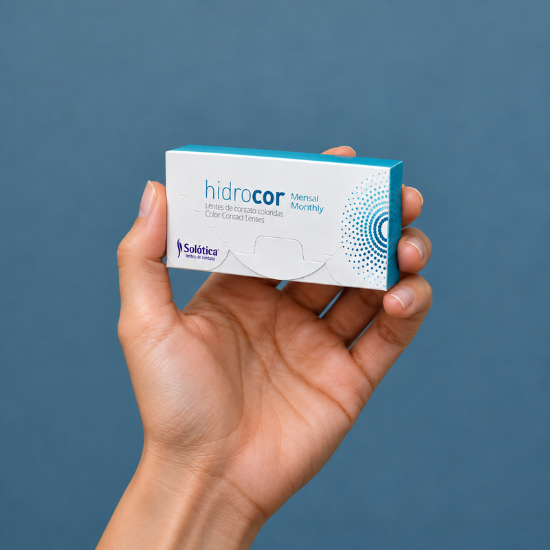Hands holding hidrocor monthly contact lens packaging