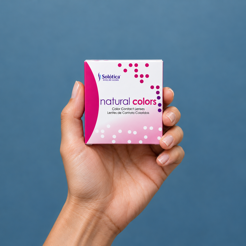 Hands holding natural colors contact lens packaging